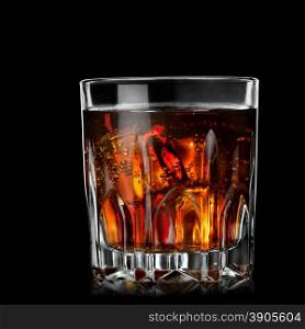 cola with cognac in glass on black