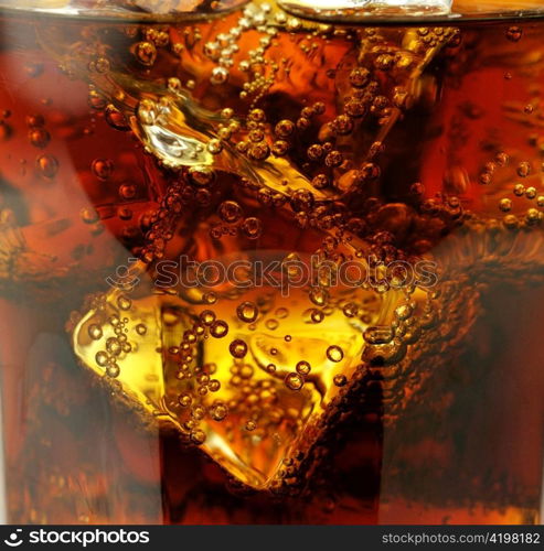 cola with ice cubes close up