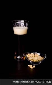 cold beer glass and peanuts, studio picture