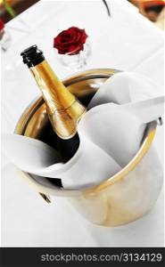 Cold bottle of champagne in bucket with ice.