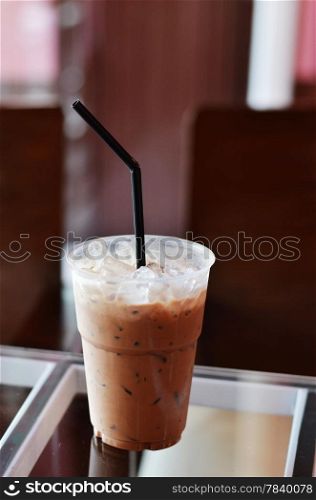 Cold coffee drink with ice on a table