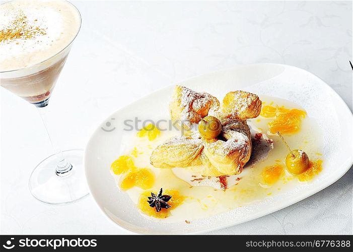 cold coffee - frappe in a tall glass and sweet pastry