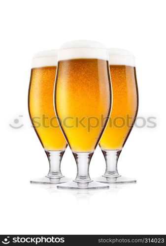 Cold elegant glasses of lager beer with foam and dew isolated on white background