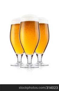 Cold elegant glasses of lager beer with foam and dew isolated on white background