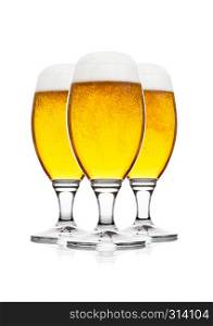 Cold elegant glasses of lager beer with foam and dew isolated on white background