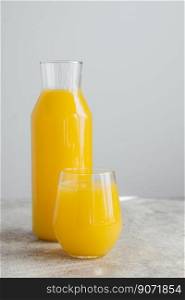 Cold fresh orange juice filled in glassware, full of vitamins, isolated over white background. Refreshing fruit drink. Isolated beverage