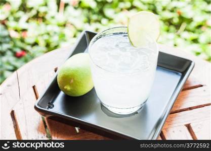 Cold glass of lime juice with lime