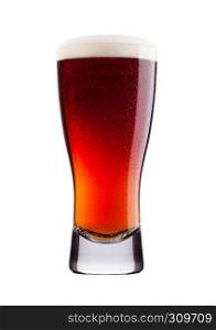 Cold glass of red bitter beer with foam and dew isolated on white background