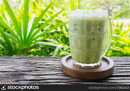 Cold Green Tea Milk Beverage or Cold Drinks Right Frame Side View. Green cold drinks and ice on wood table for drink