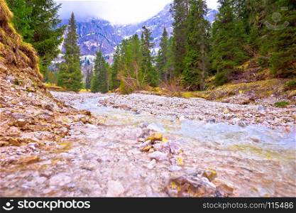 Cold mountain creek in Alps view, Gislergruppe mountain peaks, South Tyrol, Italy