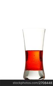 cold red drink. a glass filled with a cold red drink on white background