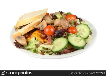 Cold salad with mushrooms, bacon and French bread on a white background.