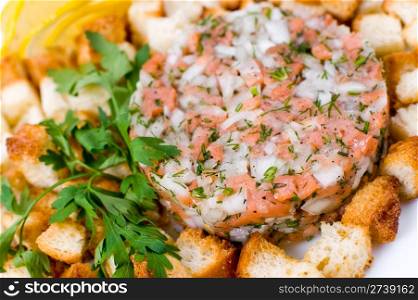 cold snack of cut salmon with onion and crusts, macro