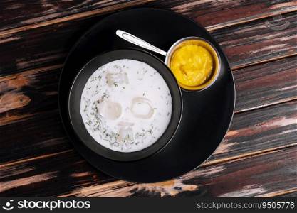 Cold soup okroshka on wooden background