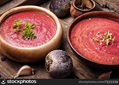 Cold summer beets soup on wooden table.Vegetarian food. Vegetable soup with beetroot