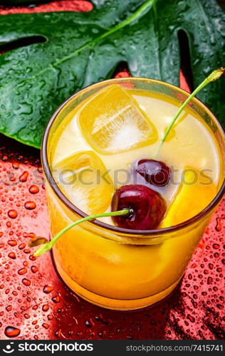 Cold summer drink with orange.Cocktail.Orange juice with ice. Orange drink with cherry