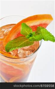 cold tea with grapefruit, lime, mint and ice on white