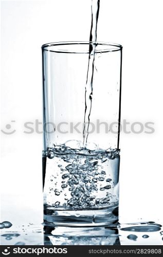 Cold water being poured into a glass.