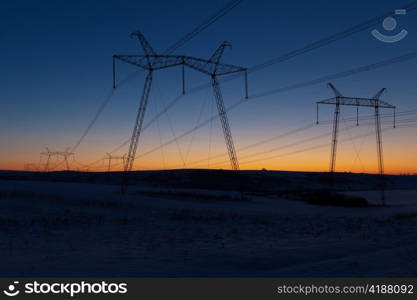 Cold winter daybreak above high voltage powerlines