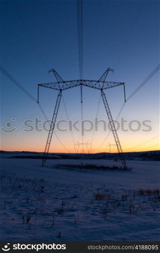 Cold winter daybreak above high voltage powerlines