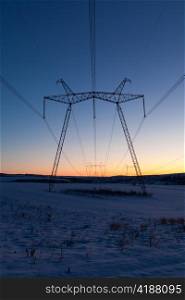 Cold winter daybreak above high voltage powerlines