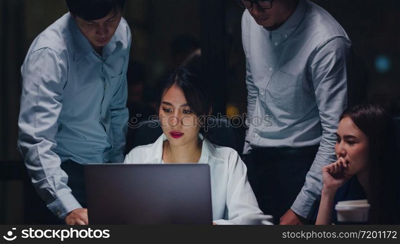 Collaborative process of multicultural businesspeople using laptop presentation and communication meeting brainstorming ideas about new project colleagues working plan success strategy in night office