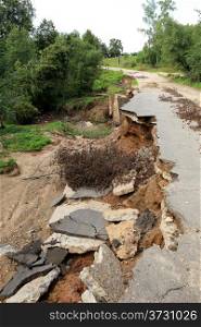 Collapse of the paved road in the forest.