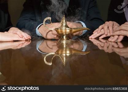 Colleagues around a smoking genie lamp