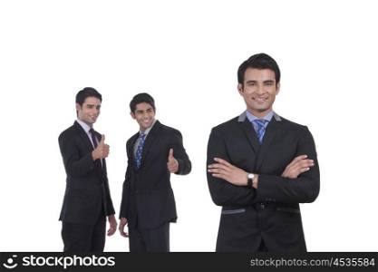 Colleagues giving thumbs up to fellow businessman