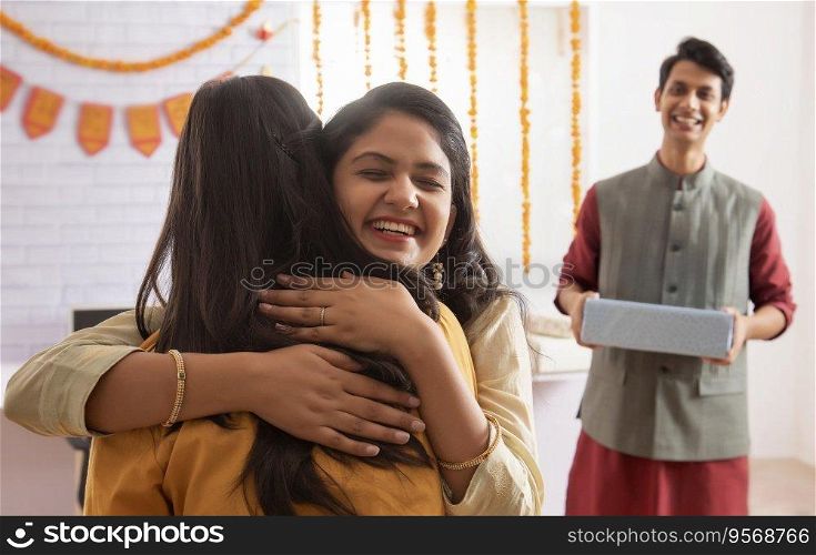 Colleagues hugging each other in office during Diwali celebrations. 