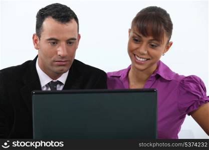 Colleagues in front of a laptop computer