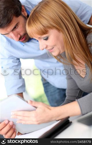 Colleagues in office with electronic tablet