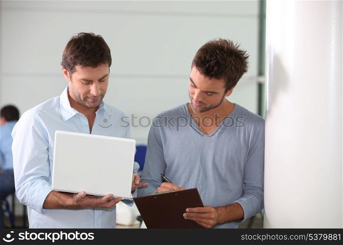 Colleagues looking at a laptop