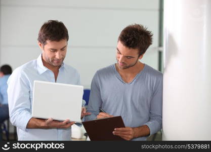 Colleagues looking at a laptop