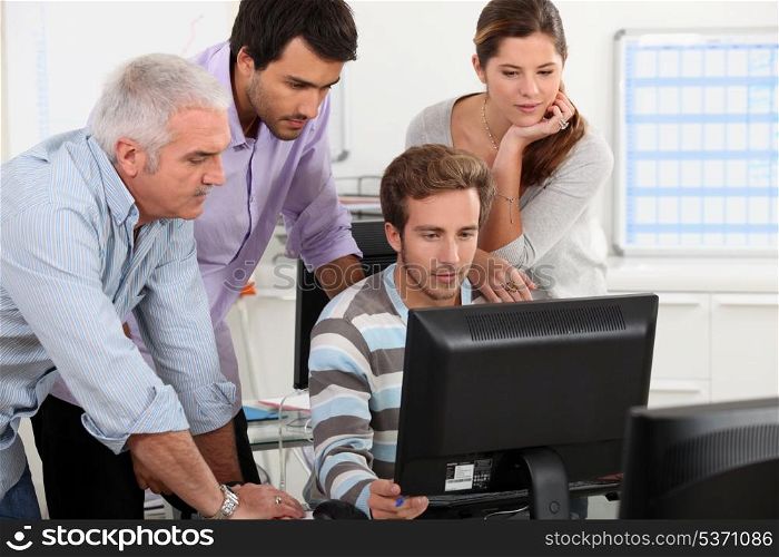 Colleagues looking at computer