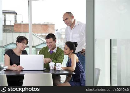 Colleagues looking at laptop