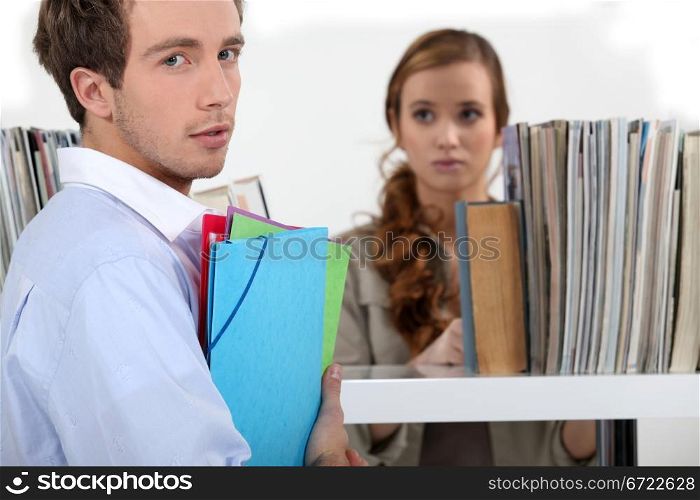 Colleagues surrounded by file folders