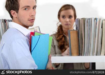 Colleagues surrounded by file folders