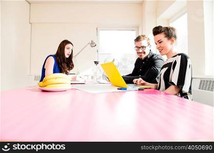Colleagues working in office meeting room