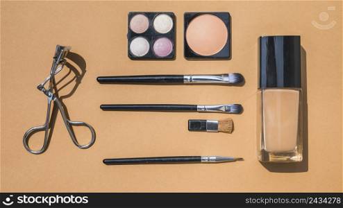 collection make up cosmetic beauty products arranged ochre background