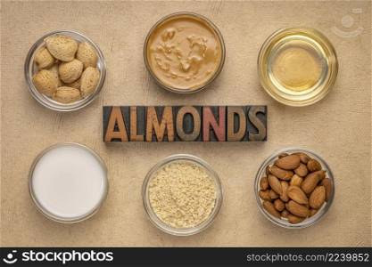 collection of almond super foods: nuts, butter, oil, milk, and flour - top view of small glass bowl with almonds word in vintage letterpress wood type