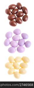 collection of chocolate coated almonds (brown, purple, white) isolated on white background