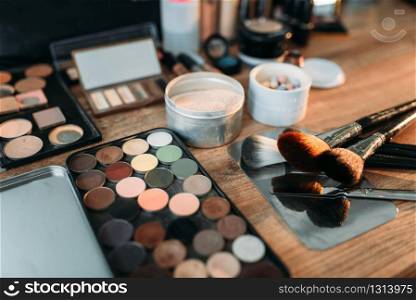 Collection of cosmetology tools on wooden table. Professional makeup artist cosmetic accessories, closeup
