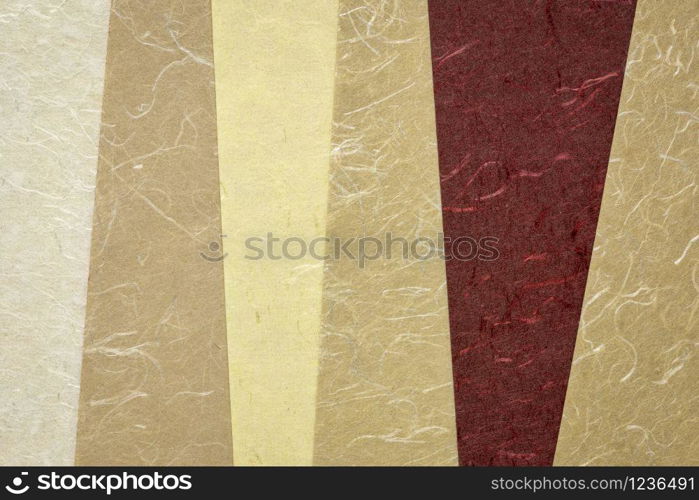 collection of handmade Indian paper created from recycled cotton fabric with silk fibers, various tones of brown color