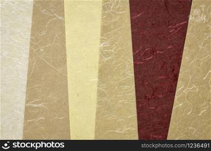 collection of handmade Indian paper created from recycled cotton fabric with silk fibers, various tones of brown color