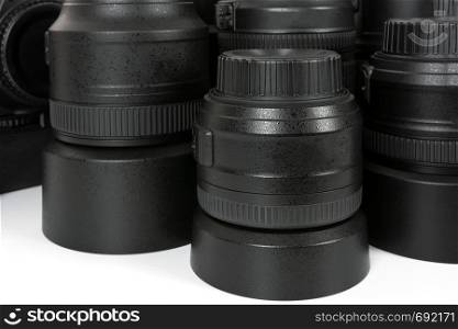 Collection of professional and modern lenses and DSLR camera in close-up.