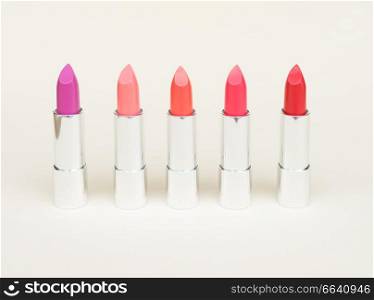 Collection of puple, pink and red shiny lipsticks. Collection of lipsticks
