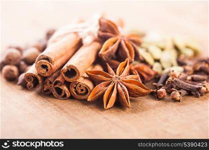 Collection of spices for mulled wine and pastry on the wooden table
