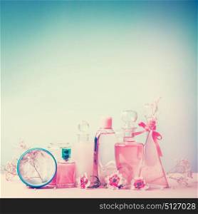 Collection of various beauty bottles and container with cosmetic products: tonic,lotion, perfume,Moisturizer,cream, soups, foams, shampoo. Pink and turquoise blue Pastel color. Beauty Cosmetic shop