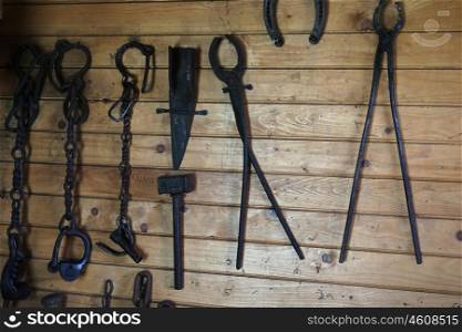 collection of vintage rustic tools on wooden wall